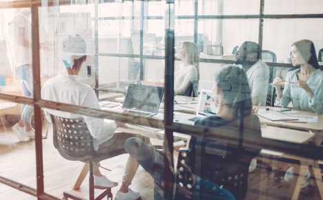 people sitting at a table in a meeting room